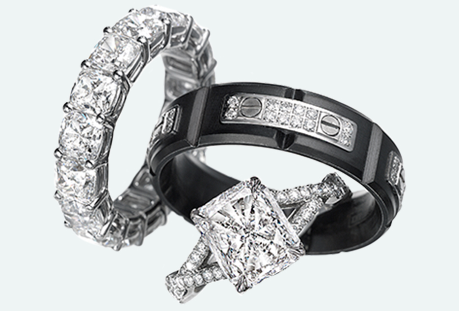 Group setting of a square four prong halo cut engagement ring and diamond wedding bands.